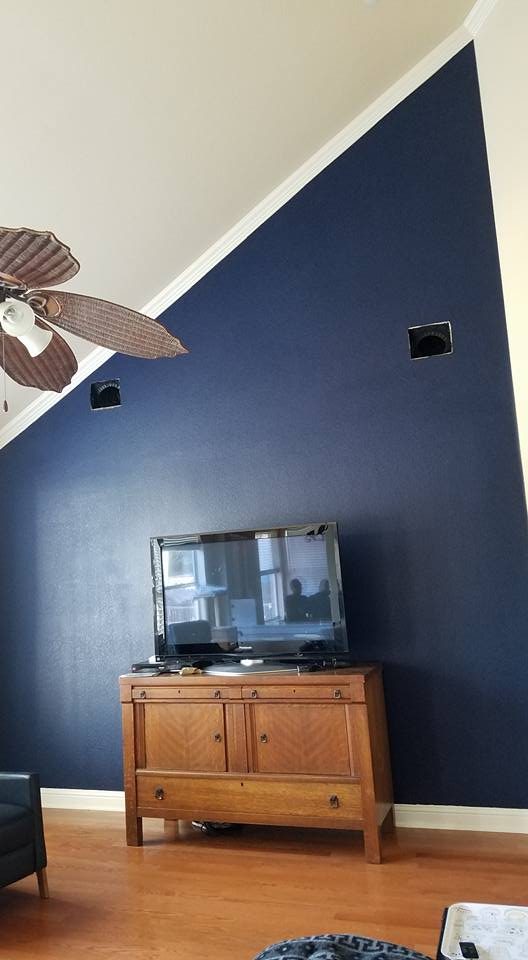 Finished living room with navy accent wall